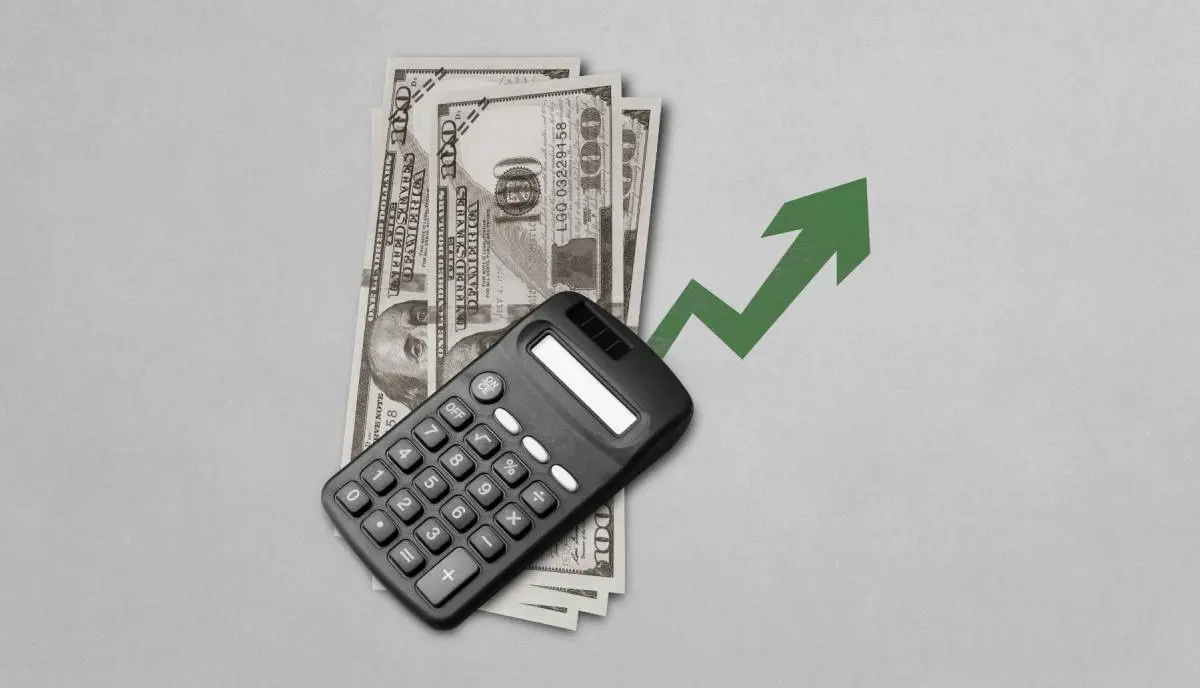 a calculator on top of a few hundred dollar bills with an arrow pointing up as a collage style of HVAC average order value increasing