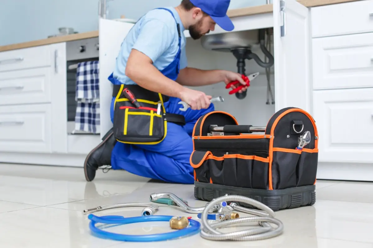 Plumber working on kitchen sink