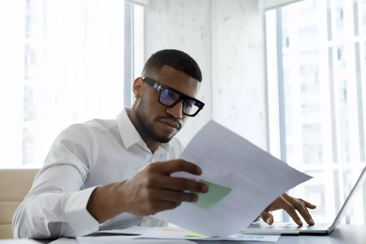 Man studying business documents for accreditation