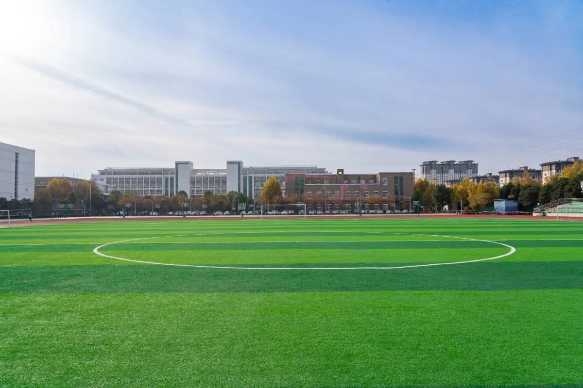 a soccer field's green artificial turf on a college campus