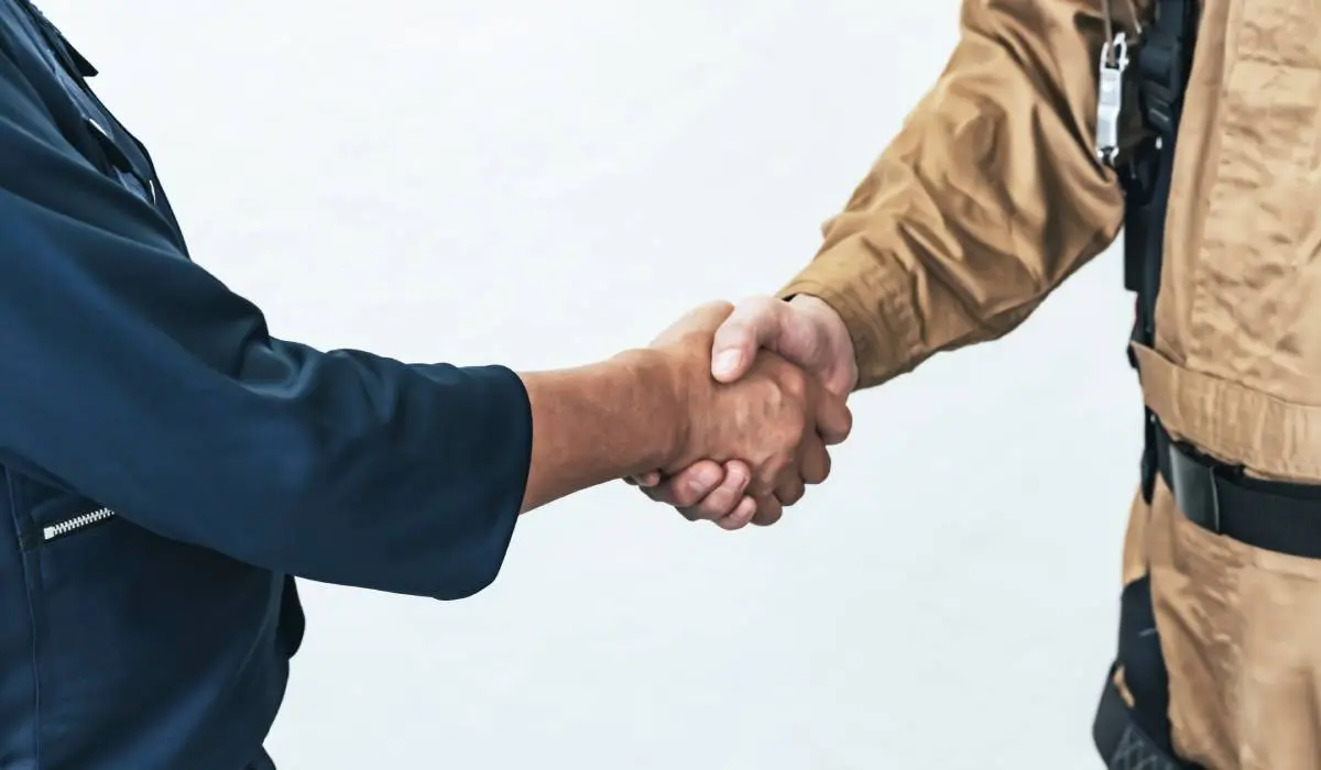 a contractor and a subcontractor shaking hands after signing an agreement