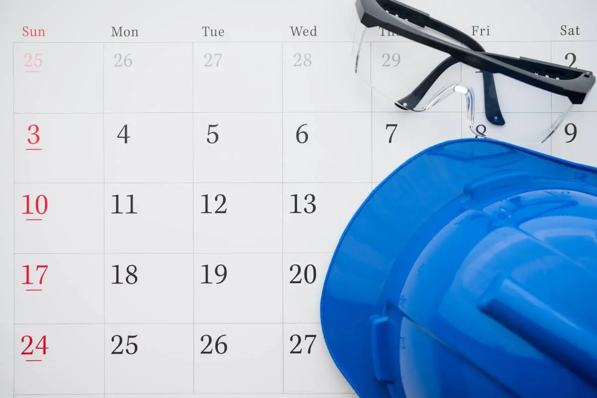 a blue hardhat and construction goggles on a calendar