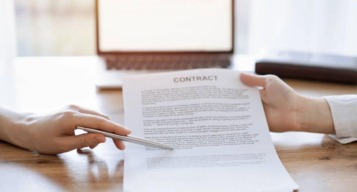 a contractor reviewing an agreement contract with a homeowner before signing