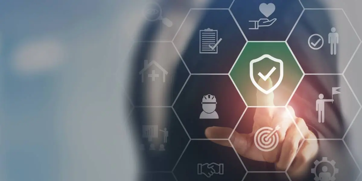 a man's finger pressing into a technology beehive pattern of symbols, including a green security shield with a checkmark, a person wearing a hard hat, a bullseye, a checklist, a person holding a flag, and two hands shaking