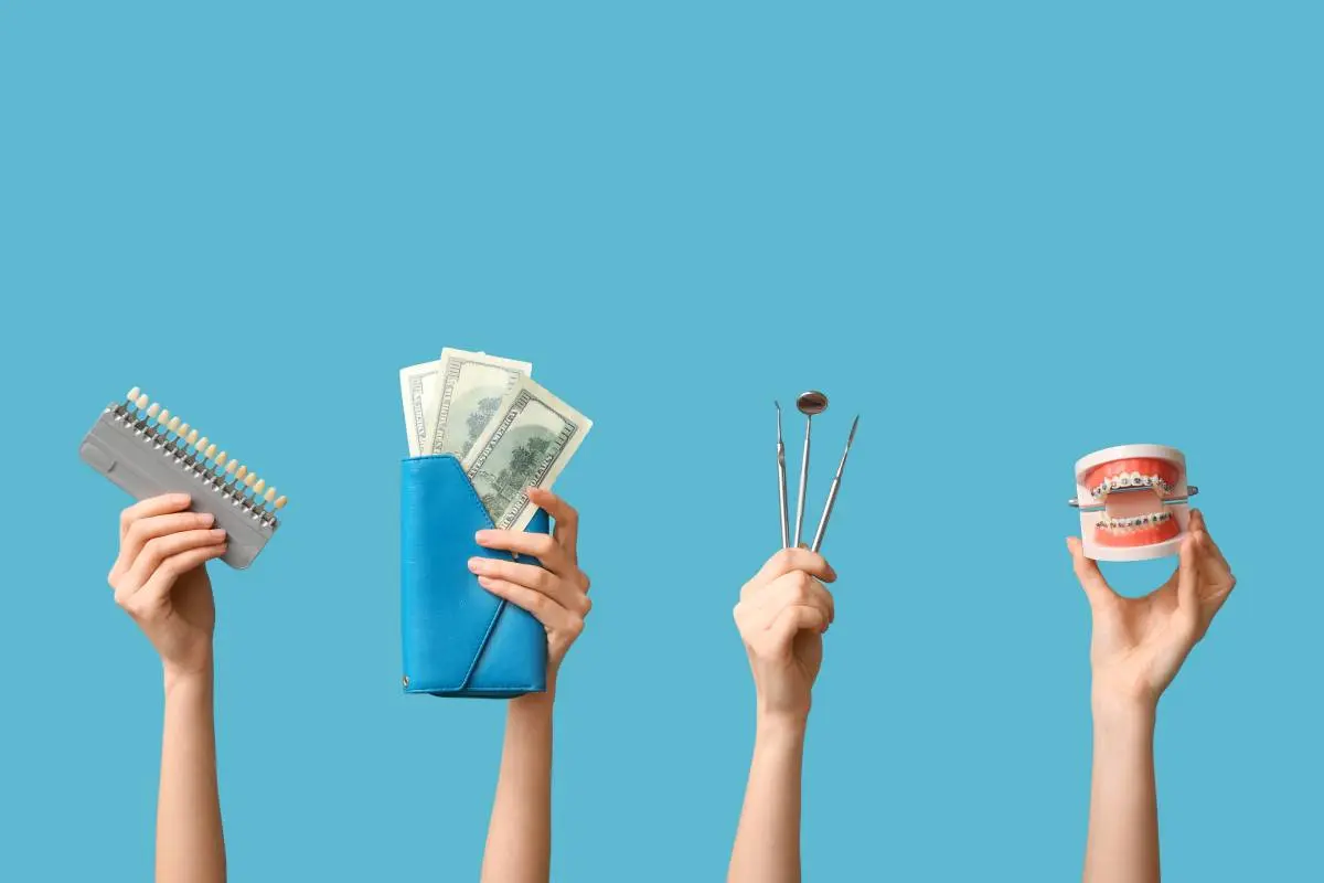 hands holding up dental tools, a teeth model, color scale of teeth, and a wallet with cash against a blue background
