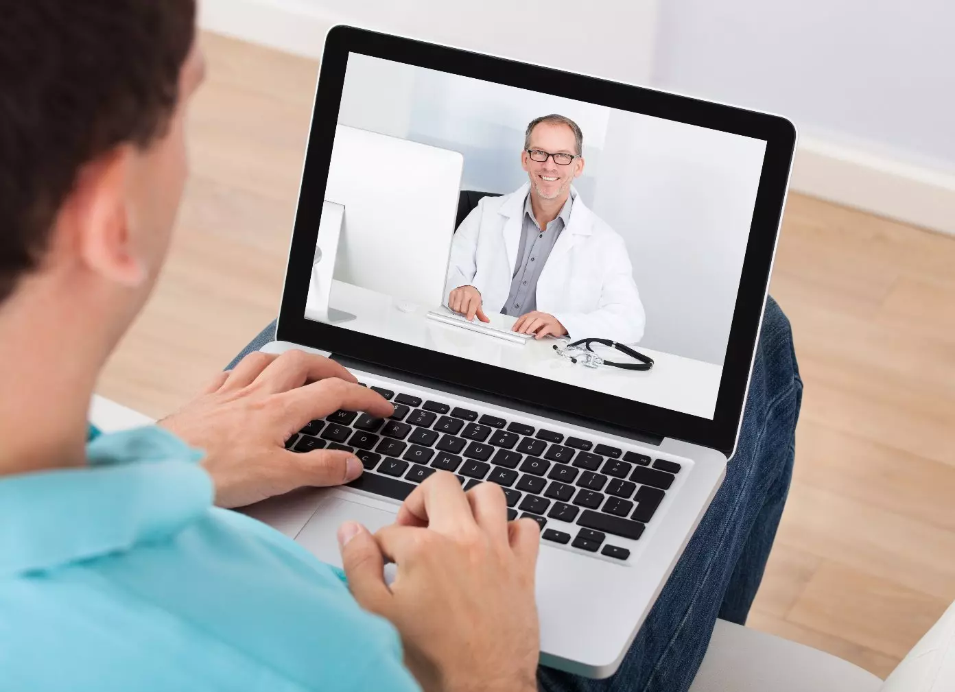 Patient watching a video online of chiropractor explaining services 
