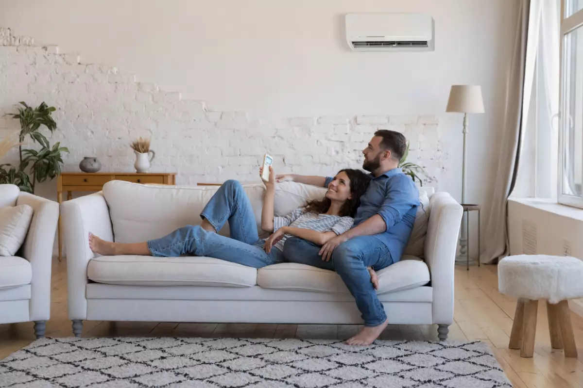 Couple relaxing on couch and enjoying HVAC unit