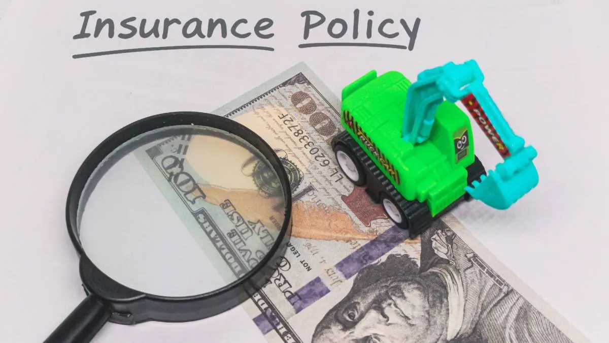 insurance policy written at the top with a magnifying glass, $100 bill, and toy excavator 