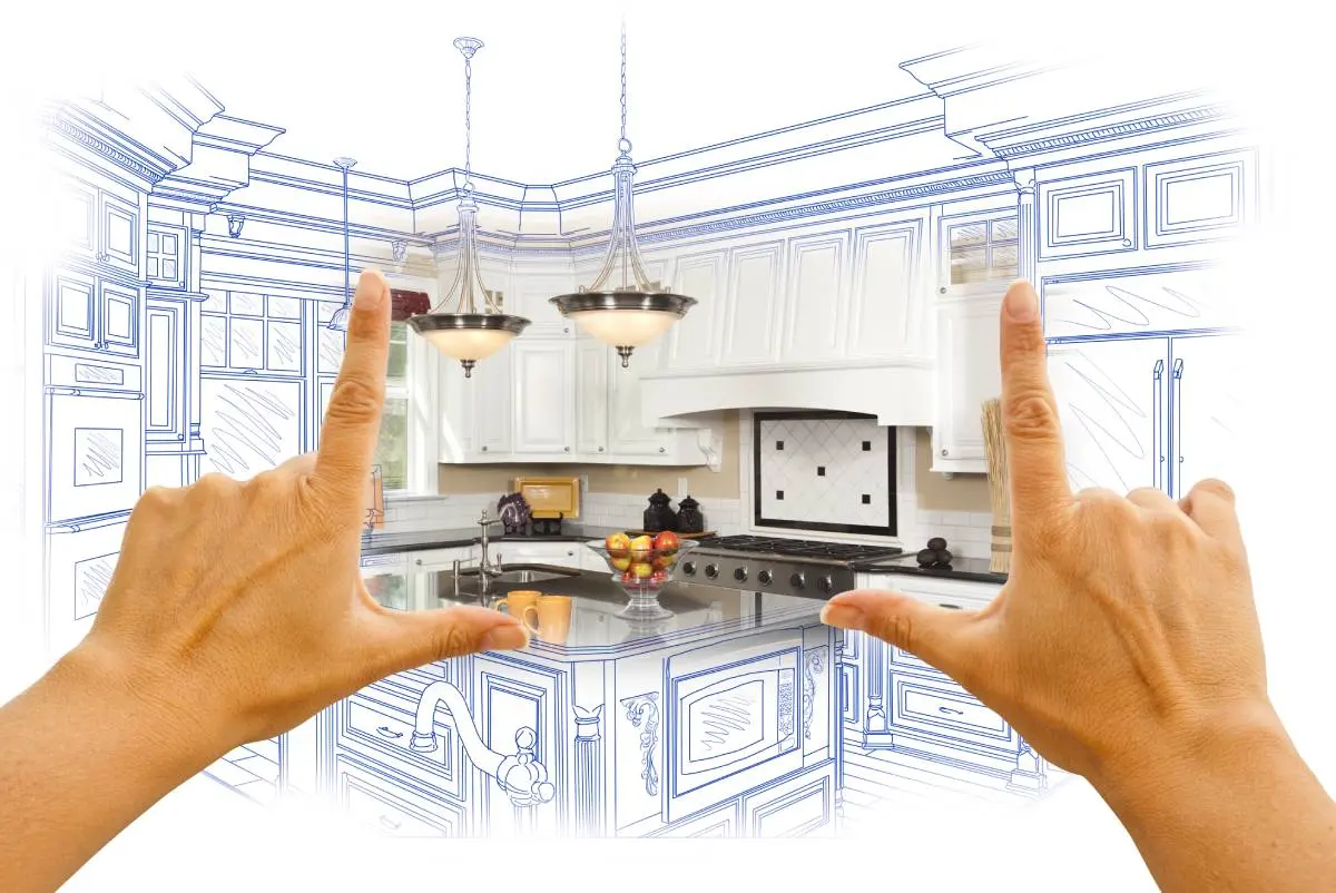 a blueprint sketch of a kitchen remodel with two hands highlighting a portion of the kitchen showcasing the remodel brought to life