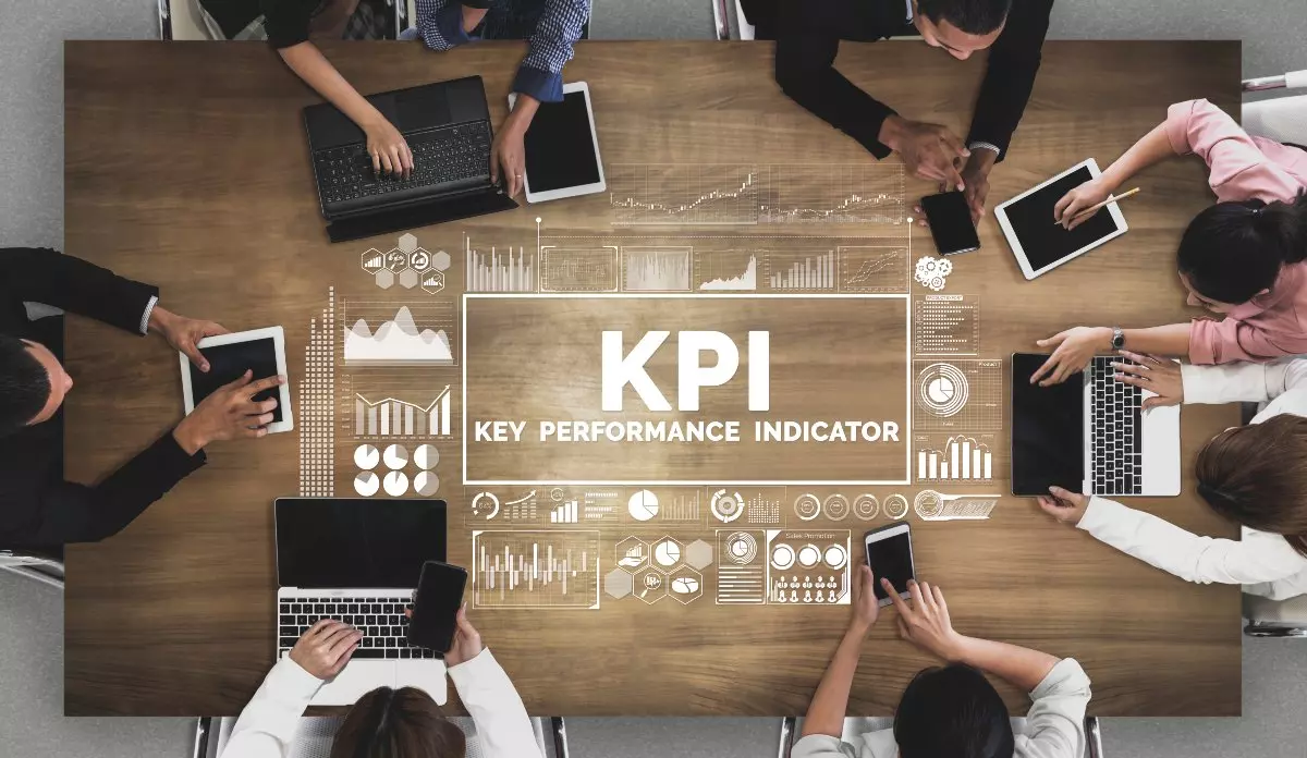 Overhead view of professional meeting with "KPI" graphic in the middle