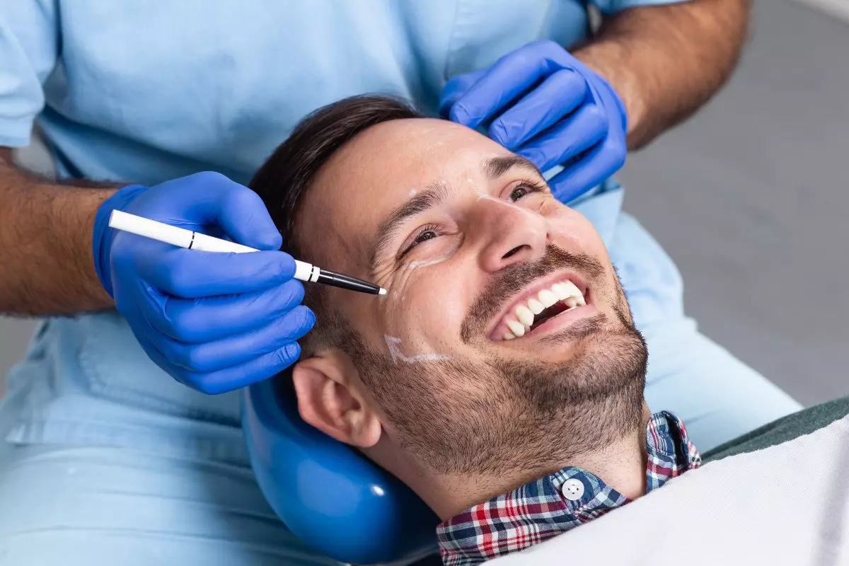 Close up on plastic surgeon consulting with smiling patient 
