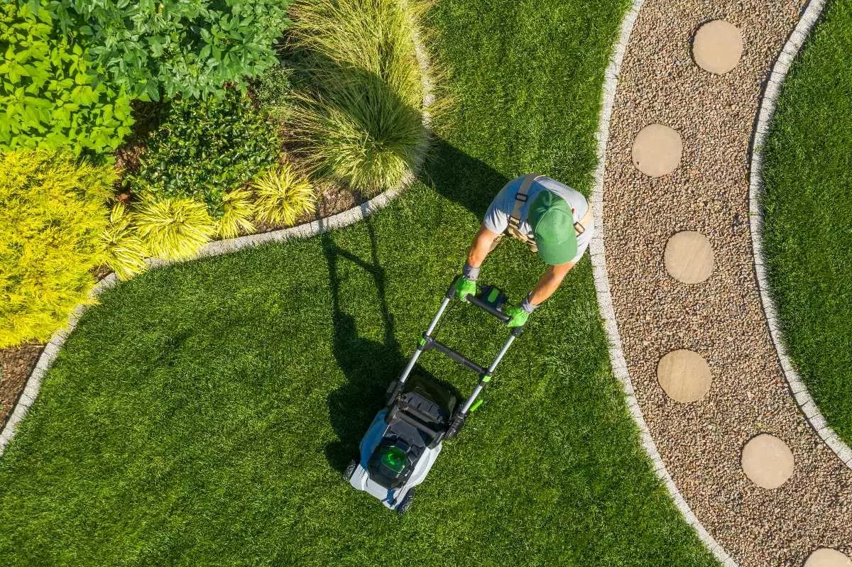 Landscaper mowing lawn