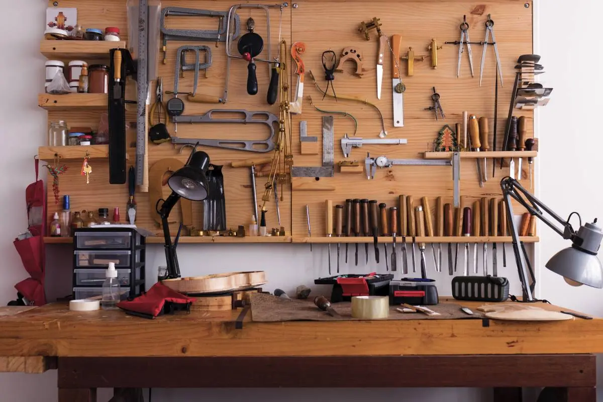 various tools used by a contractor or carpenter in their storage space above a wooden working table