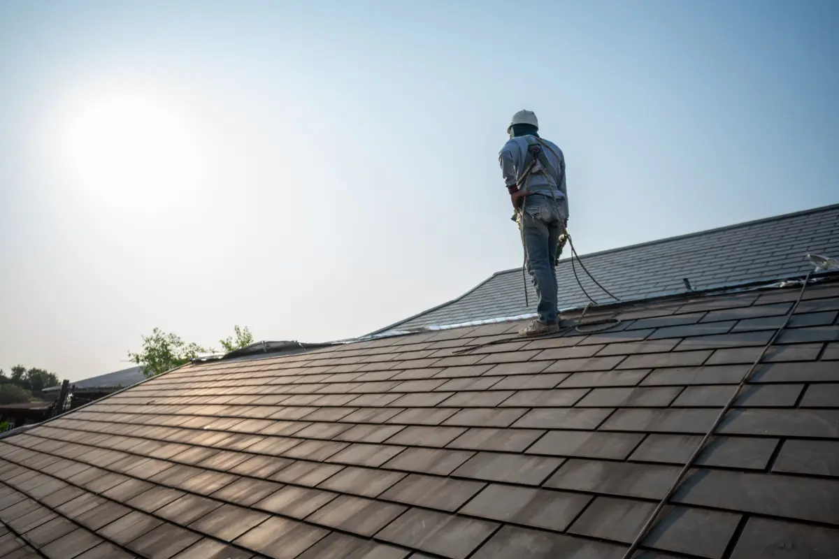 Roofer working on top of the roof.