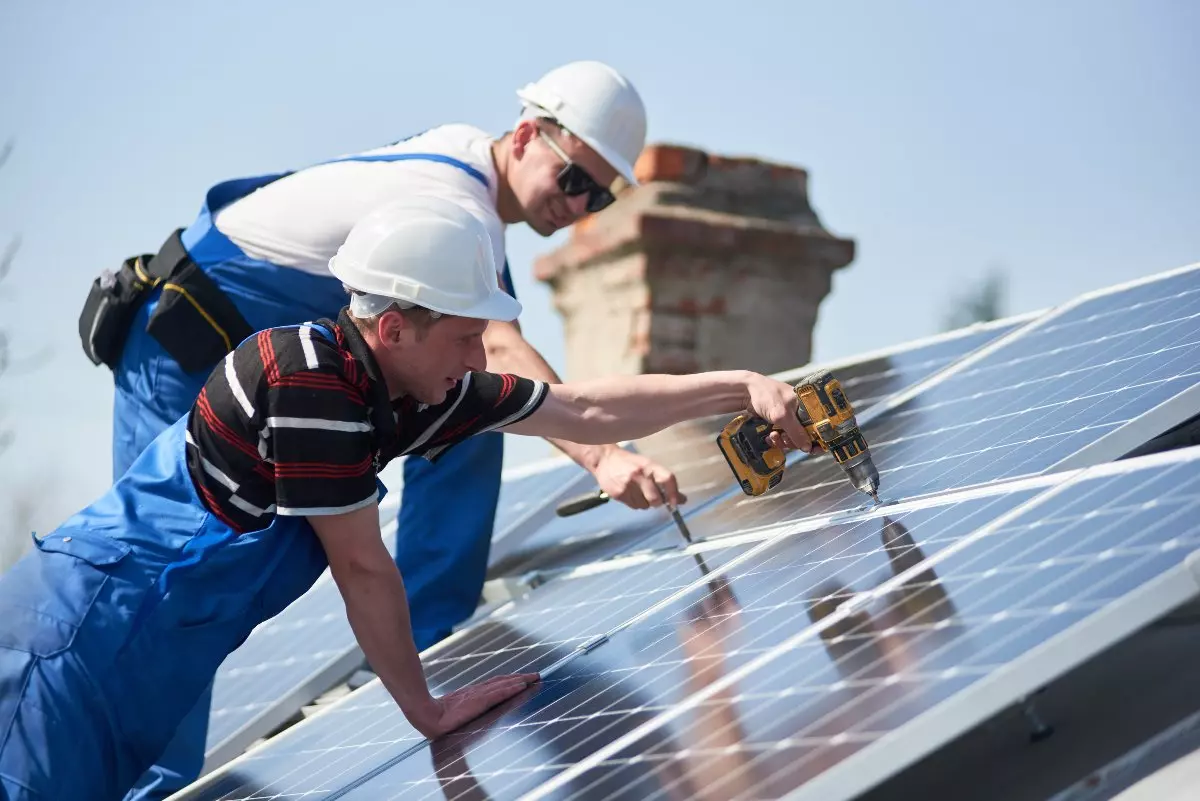 Professionals installing solar panels