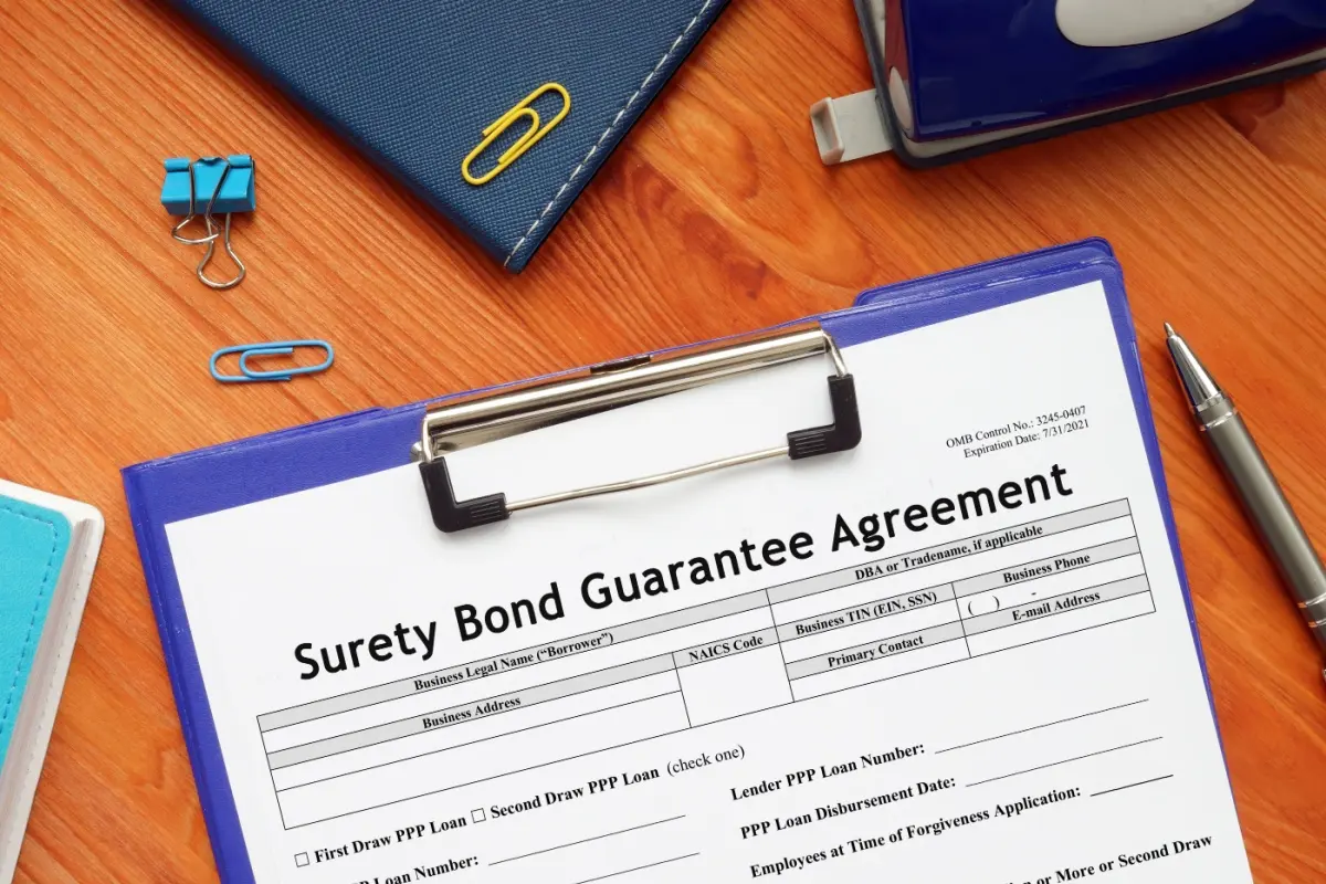 Clipboard with a Surety Bond Guarantee agreement on it.