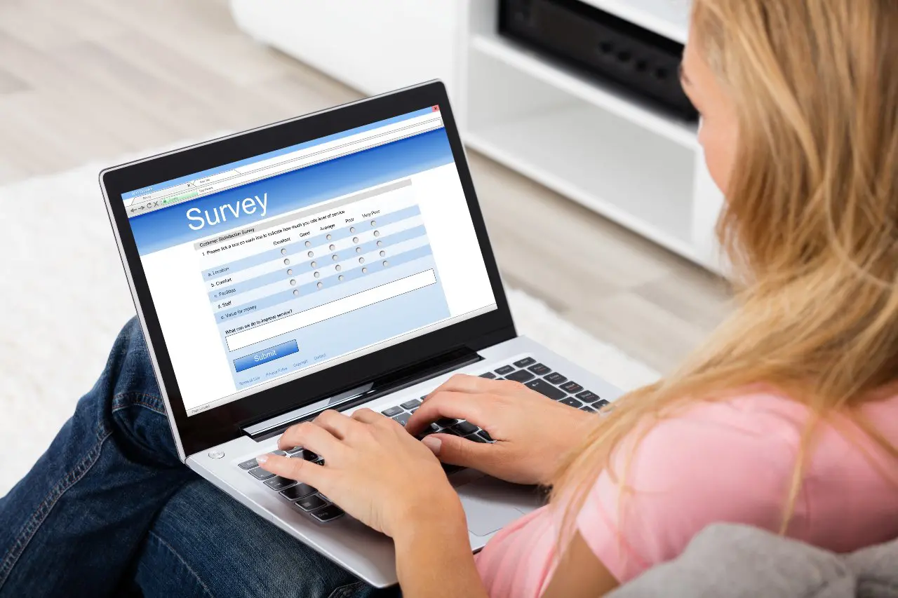 Consumer taking survey on laptop.