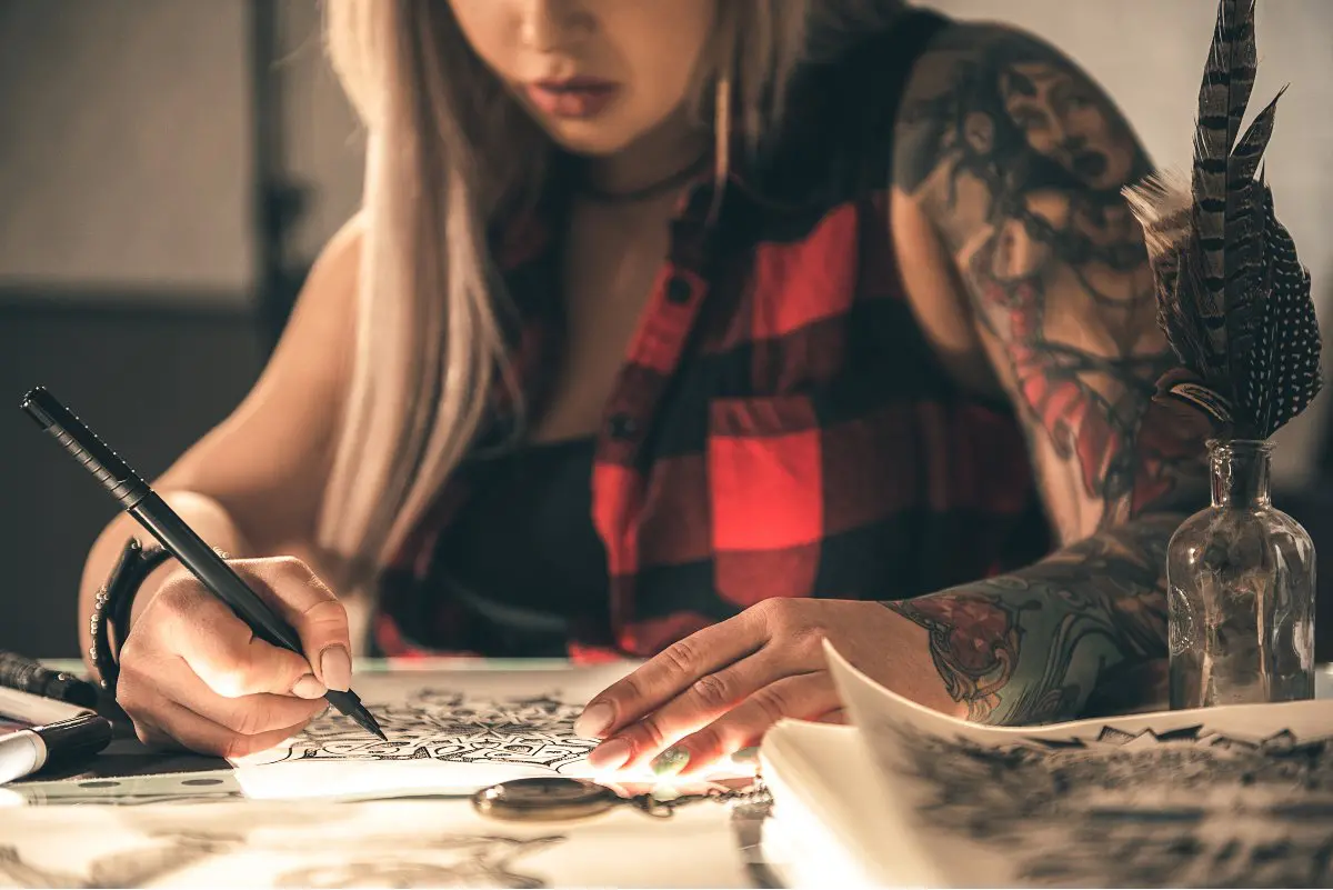 Tattoo artist drawing a design
