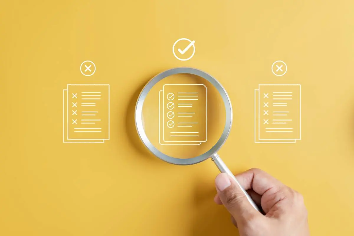 a magnifying glass highlighting a completed and approved application alongside incomplete and rejected applications on a yellow background